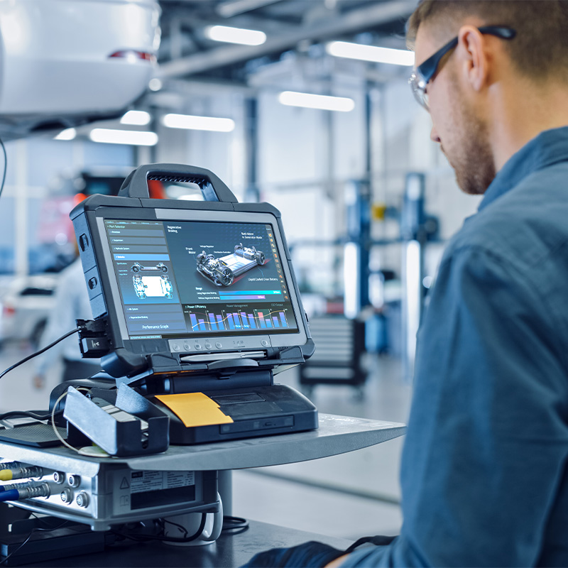 Worker overseeing the manufacturing of a vehicle