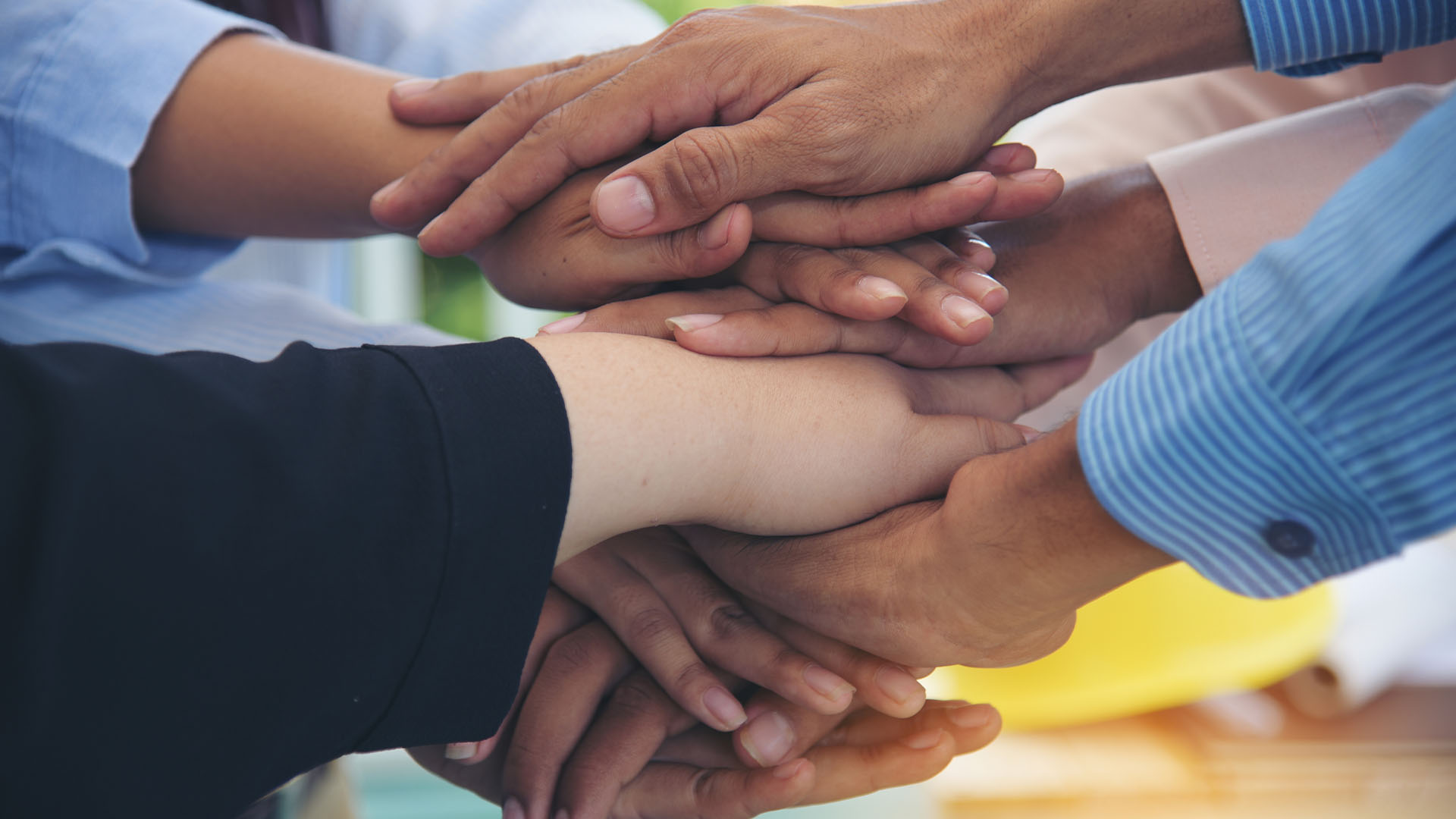 Hands all together in a pile